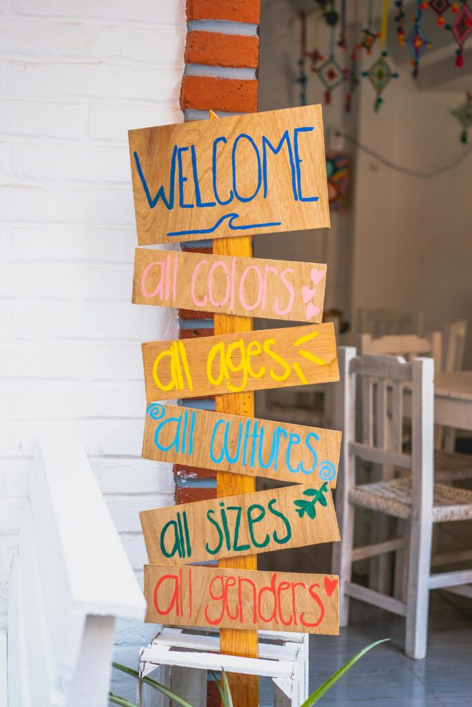 A vibrant welcome sign in a cozy cafe with inclusive messages and eye-catching colors.
